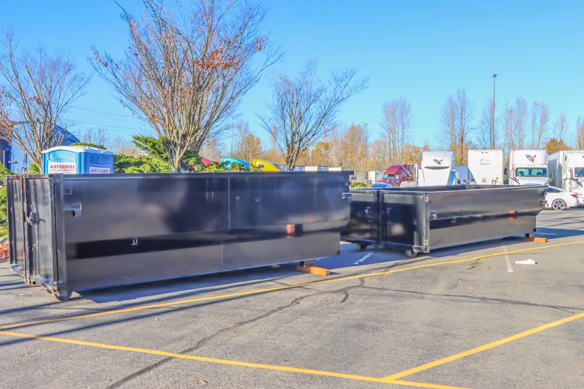 Professional dumpster rental service with roll-off container on residential driveway in Hubbard